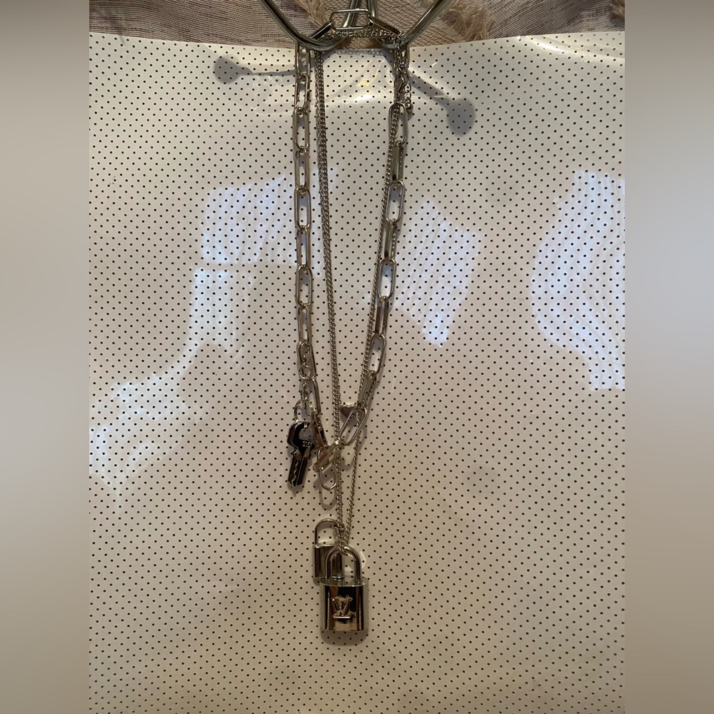 #315 Louis Vuitton silver lock with 2 keys on unbranded chain.